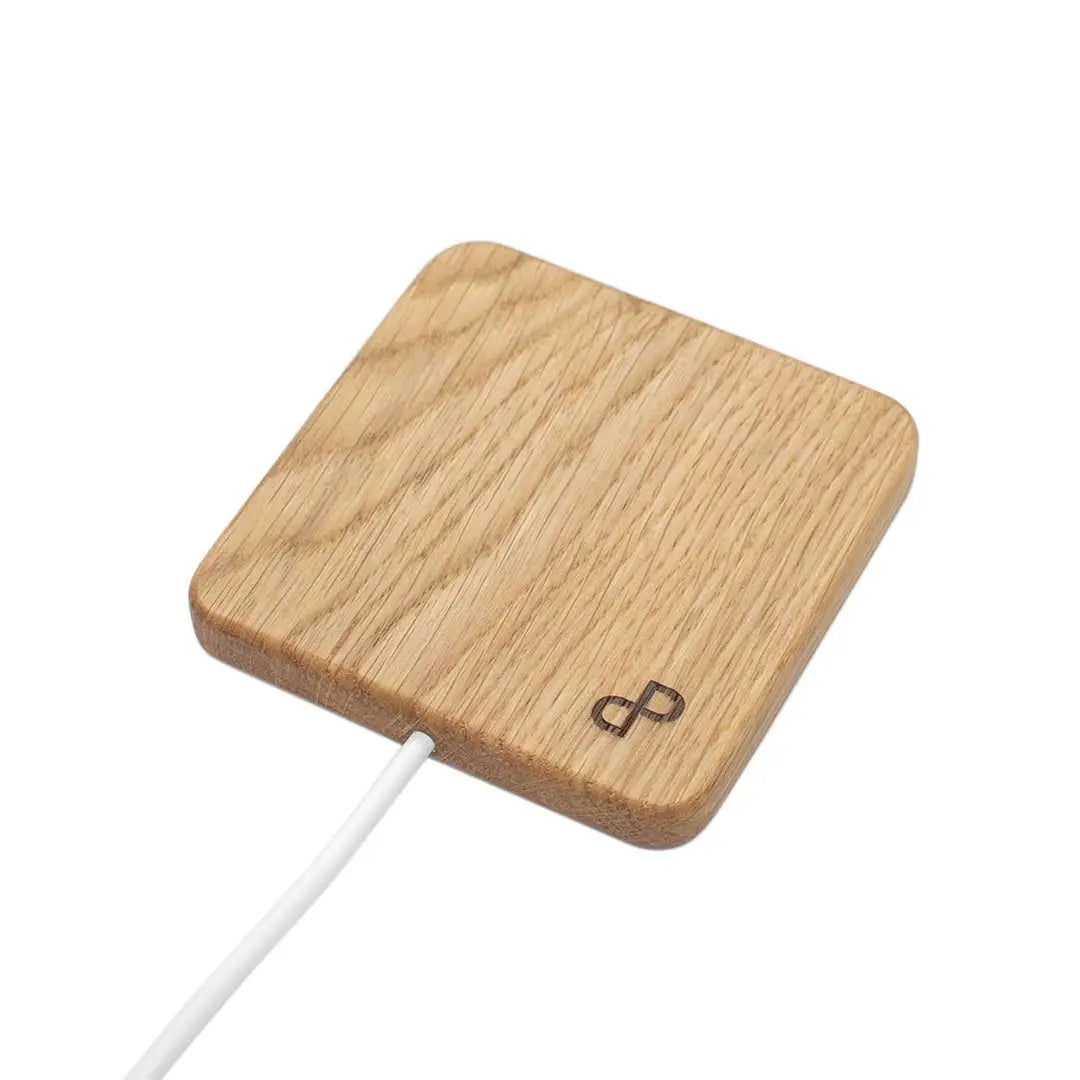 Handcrafted wooden wireless charger with elegant design and QI technology for fast charging.